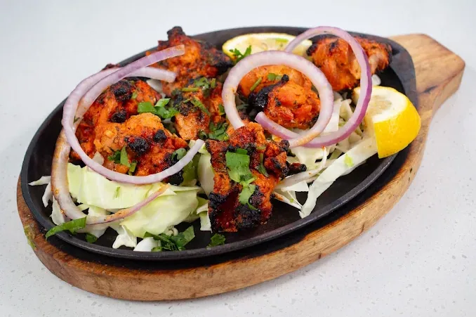 Chicken tikka, sizzling.