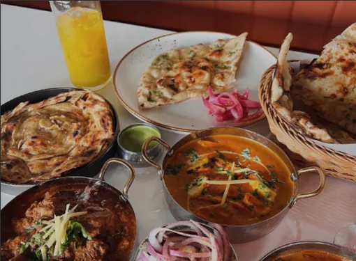 Tikka King catering spread — multiple dishes in serving bowls